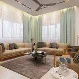 Modern corner living room seating with beige sofas, wooden accent chair, round coffee table, rug, and light filled space